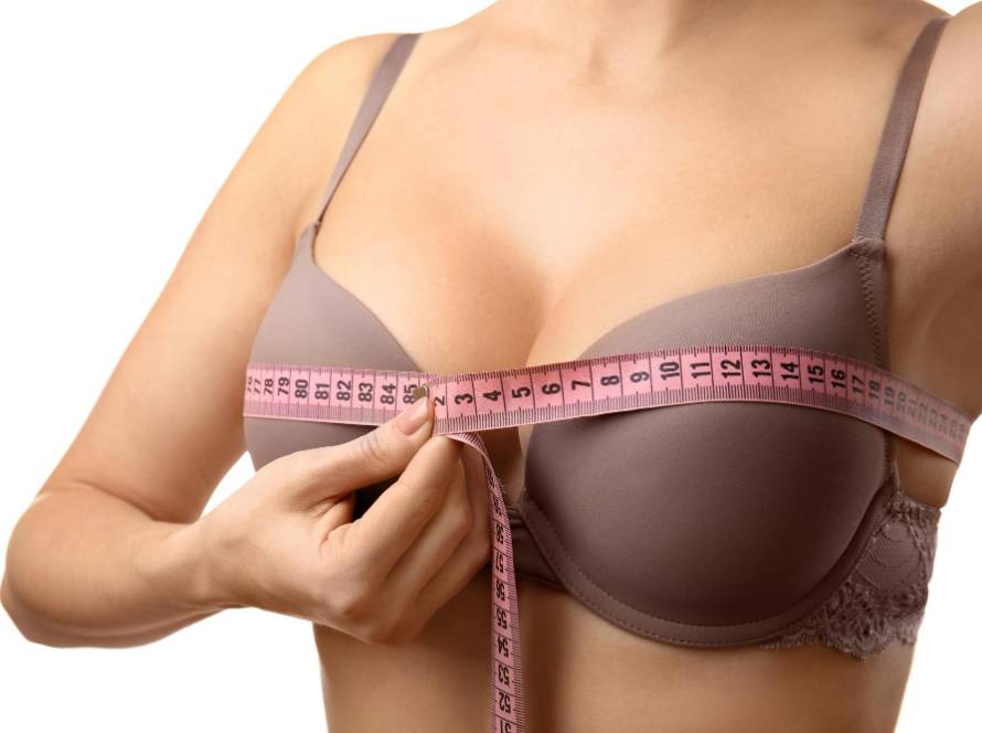 Woman measuring bust size before breast augmentation surgery in Tijuana