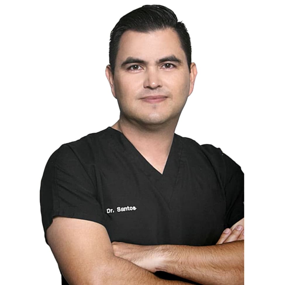 Portrait of a medical professional in black scrubs with arms crossed, posing against a white background.